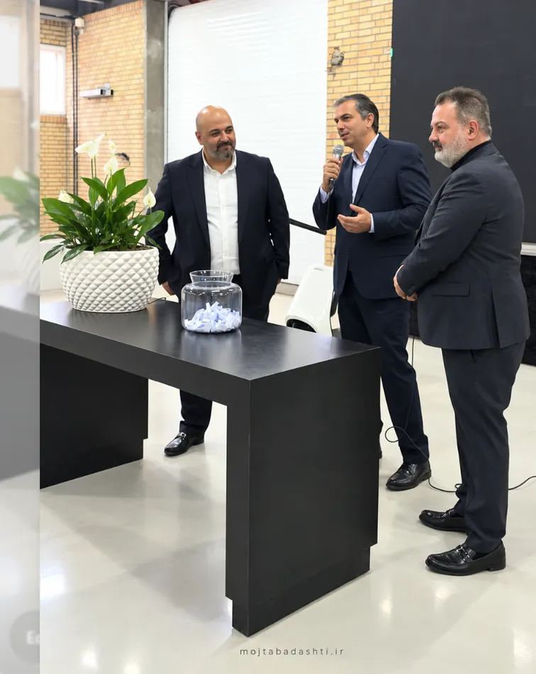 Mojtaba Dashti speaking at a professional event with business colleagues